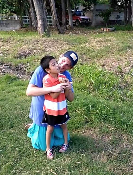 James Kasza embracing a young boy during a service trip in Guatemala