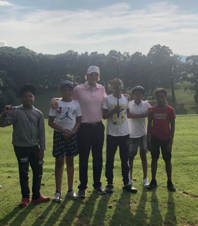 James Kasza mentoring a group of young golfers in the community